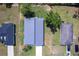 An aerial view shows the home's modern roof, short driveway, and neighboring homes at 14350 Marlin Ave, Port Charlotte, FL 33953
