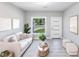 Cozy living room featuring neutral tones, stylish decor, and ample natural light at 14350 Marlin Ave, Port Charlotte, FL 33953