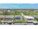 Real estate featuring a screened-in pool, with manicured lawn and canal at 15148 Taurus Cir, Port Charlotte, FL 33981