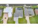 Aerial view of waterfront homes, showcasing backyard pools and boat docks on a sunny day at 15148 Taurus Cir, Port Charlotte, FL 33981