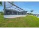Lovely backyard with a spacious lanai, pool, and waterfront canal access at 15148 Taurus Cir, Port Charlotte, FL 33981