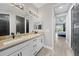 Elegant bathroom features a double vanity with granite countertops and black hardware at 15148 Taurus Cir, Port Charlotte, FL 33981