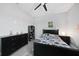 Bedroom with grey flooring, ceiling fan, dark furniture, and colorful video game themed decor at 15148 Taurus Cir, Port Charlotte, FL 33981
