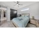Bedroom features a comfortable bed, ceiling fan, and closet at 15148 Taurus Cir, Port Charlotte, FL 33981