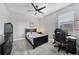 Bedroom with ceiling fan, grey flooring, and video game themed decor and black furniture at 15148 Taurus Cir, Port Charlotte, FL 33981