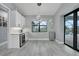 Bright dining area featuring modern light fixture and views of the pool at 15148 Taurus Cir, Port Charlotte, FL 33981