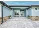 Inviting front entrance with seating area and stone accents, creating a warm welcome at 15148 Taurus Cir, Port Charlotte, FL 33981
