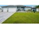 Well-maintained lawn leads to a charming home with a two-car garage at 15148 Taurus Cir, Port Charlotte, FL 33981