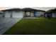 Beautiful home showcasing a well-kept lawn and a spacious two-car garage at 15148 Taurus Cir, Port Charlotte, FL 33981