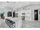 Modern kitchen with a large island, sleek countertops, stainless steel appliances, and pendant lighting at 15148 Taurus Cir, Port Charlotte, FL 33981