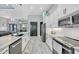 Well-designed kitchen with a central island, stainless steel appliances, and seamless flow to other living areas at 15148 Taurus Cir, Port Charlotte, FL 33981