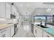 Bright, open kitchen features white cabinets, stainless steel appliances, and granite countertops at 15148 Taurus Cir, Port Charlotte, FL 33981