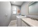 Functional laundry room featuring modern washer/dryer units and a utility sink at 15148 Taurus Cir, Port Charlotte, FL 33981