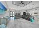 Bright and airy living room featuring a large sectional, stylish furnishings, and modern lighting at 15148 Taurus Cir, Port Charlotte, FL 33981
