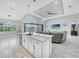 Spacious open-plan living room with modern lighting and seamless access to outdoor pool area at 15148 Taurus Cir, Port Charlotte, FL 33981