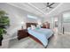 Comfortable main bedroom suite features a ceiling fan and access to the screened-in patio at 15148 Taurus Cir, Port Charlotte, FL 33981