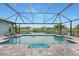 Screened-in pool and deck overlooking a canal with waterfront views in a relaxing setting at 15148 Taurus Cir, Port Charlotte, FL 33981
