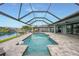 Sparkling pool with lovely screened-in lanai, offering stunning views of the community canal at 15148 Taurus Cir, Port Charlotte, FL 33981