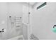 Sleek glass shower with white marble-style tiling and a decorative mosaic floor at 15148 Taurus Cir, Port Charlotte, FL 33981