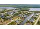 This aerial view showcases a waterfront community with beautiful homes lining canals and lush tropical landscaping at 15890 Viscount Cir, Port Charlotte, FL 33981