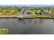 Aerial view of waterfront home with a dock and a boat at 15890 Viscount Cir, Port Charlotte, FL 33981