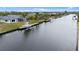A serene waterfront setting with a private dock, perfect for boating, and a home with a screened-in pool at 15890 Viscount Cir, Port Charlotte, FL 33981