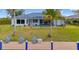 A view of the waterfront from the backyard featuring a covered lanai and private dock for boating and recreation at 15890 Viscount Cir, Port Charlotte, FL 33981