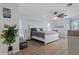 Spacious main bedroom boasts wood-look floors, a ceiling fan, and a relaxing sitting area at 15890 Viscount Cir, Port Charlotte, FL 33981