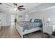 Cozy bedroom with wood-look floors, neutral decor, and a view to the entryway at 15890 Viscount Cir, Port Charlotte, FL 33981