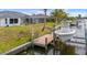 Waterfront home featuring a private boat lift and dock on the canal at 15890 Viscount Cir, Port Charlotte, FL 33981