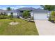 Well-maintained home with a landscaped front yard and a spacious driveway leading to an attached two-car garage at 15890 Viscount Cir, Port Charlotte, FL 33981