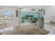 Bright living room and kitchen area featuring a breakfast bar and tranquil water views at 15890 Viscount Cir, Port Charlotte, FL 33981