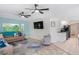 Open living area with a comfortable sofa, ceiling fans, and a view of the kitchen at 15890 Viscount Cir, Port Charlotte, FL 33981