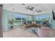 Spacious living room with a large sectional sofa, ceiling fans, and expansive water views at 15890 Viscount Cir, Port Charlotte, FL 33981