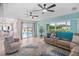 Open-concept living room with pool views, comfortable seating, and easy access to the kitchen at 15890 Viscount Cir, Port Charlotte, FL 33981