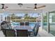 Outdoor patio with a dining table, chairs, and views of the pool and canal at 15890 Viscount Cir, Port Charlotte, FL 33981