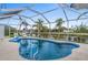 Private screened-in pool with inviting cool blue water and lounge chairs at 15890 Viscount Cir, Port Charlotte, FL 33981