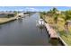 View of a private boat dock, showcasing waterfront living on a calm canal at 15890 Viscount Cir, Port Charlotte, FL 33981