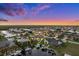 Aerial view of waterfront home with boat dock and lush tropical landscaping at dusk at 1932 Los Alamos Dr, Punta Gorda, FL 33950