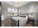Cozy bedroom with white walls, wood floors, shuttered windows and wrought iron bed frame at 1932 Los Alamos Dr, Punta Gorda, FL 33950