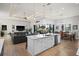 Open-concept kitchen with white island, stainless steel appliances, and seamless flow to dining and living areas at 1932 Los Alamos Dr, Punta Gorda, FL 33950