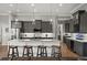 Modern kitchen features an island with seating, stainless steel appliances, and dark cabinets at 1932 Los Alamos Dr, Punta Gorda, FL 33950