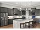 Modern kitchen boasts gray cabinets, stainless steel appliances, and a center island with barstool seating at 1932 Los Alamos Dr, Punta Gorda, FL 33950