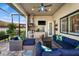 Outdoor seating area with blue cushions, brick pavers, and built-in grill at 1932 Los Alamos Dr, Punta Gorda, FL 33950