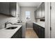 Laundry room features grey cabinetry, white countertop, washer, and dryer at 1932 Los Alamos Dr, Punta Gorda, FL 33950