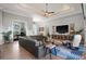 Open living room features a large sectional sofa, desk, and a decorative tray ceiling at 1932 Los Alamos Dr, Punta Gorda, FL 33950