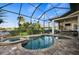 Backyard pool and spa with a screened enclosure and brick pavers at 1932 Los Alamos Dr, Punta Gorda, FL 33950