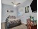 Comfortable bedroom with a large window, grey walls and wood floors at 2028 Lynx Run, North Port, FL 34288