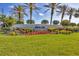 Welcoming entrance with beautiful landscaping, flowers, and clear signage for Bobcat Trail at 2028 Lynx Run, North Port, FL 34288