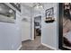 Inviting foyer with wood-look floors, modern light fixture, and views to other rooms of the house at 2028 Lynx Run, North Port, FL 34288